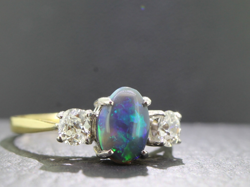 Stunning black australian opal and diamond 18 carat gold trilogy ring
