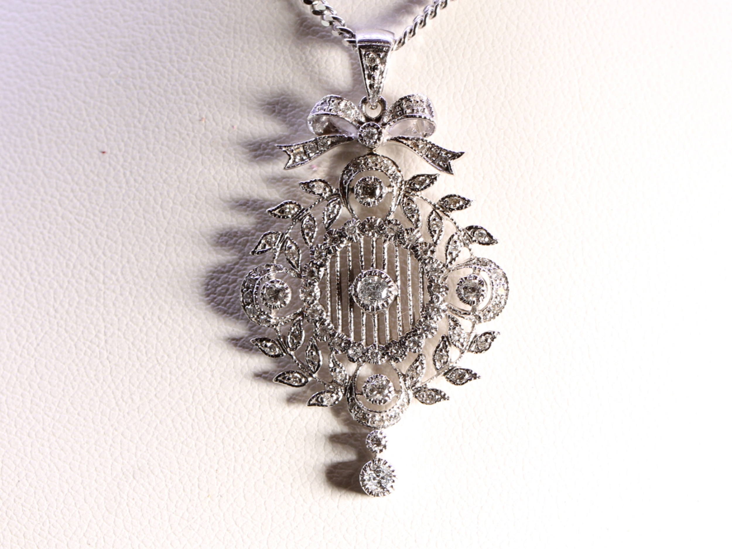 Vintage circular diamond set garland floral 18ct gold pendant