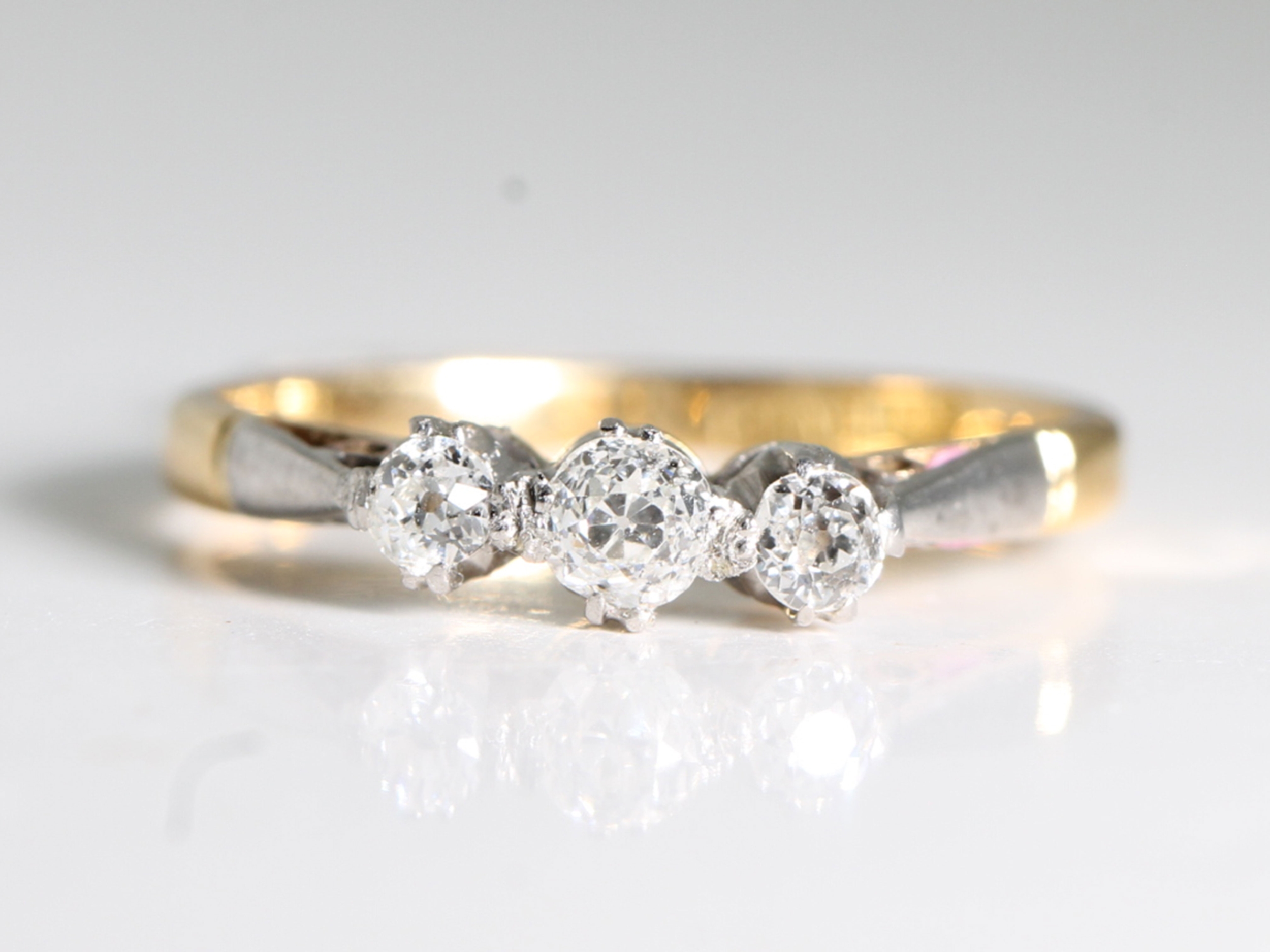 Art deco diamond platinum and 18ct gold trilogy ring