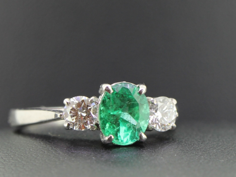 A mesmerising emerald and diamond trilogy 18 carat gold ring