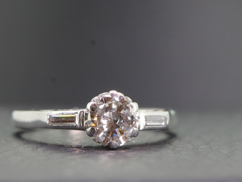 Gorgeous diamond solitaire with diamond baguette shoulders crafted in platinum