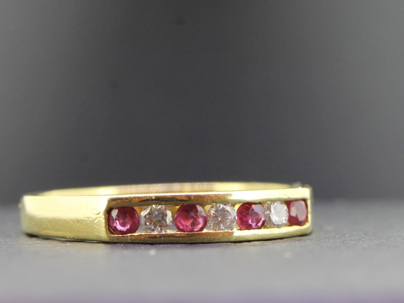 Lovely ruby and diamond half eternity 18 carat gold ring
