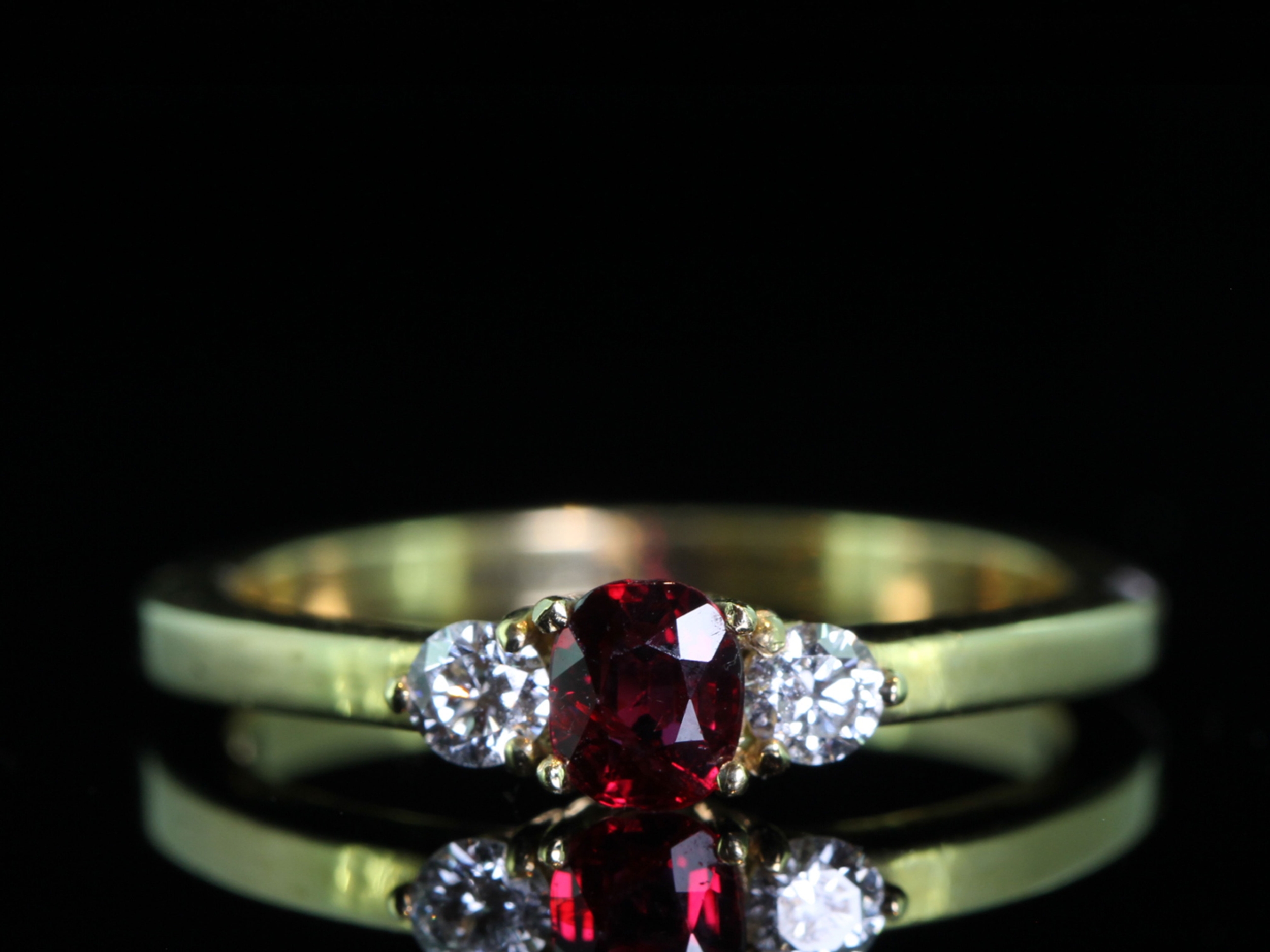 Pretty ruby and diamond 18 carat gold trilogy ring