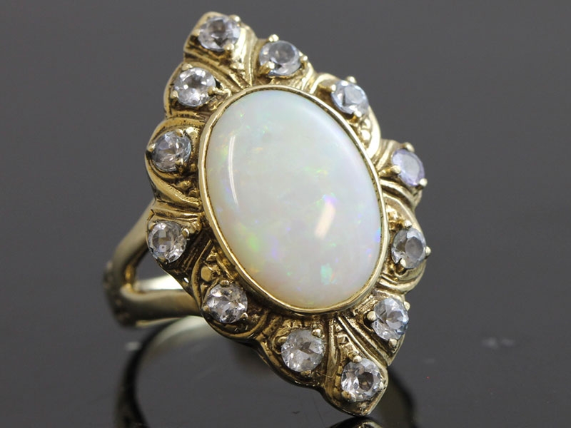 Stylish revival inspired turn of the century 9 carat opal and blue zircon ring