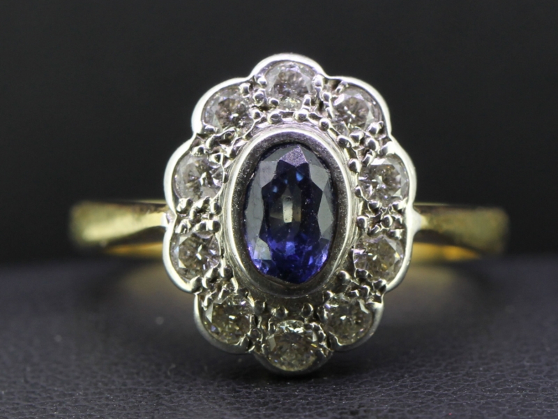 Striking ceylon sapphire and diamond 18 carat gold cluster ring