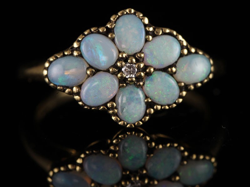 A very pretty  9 carat gold opal and diamond flower ring