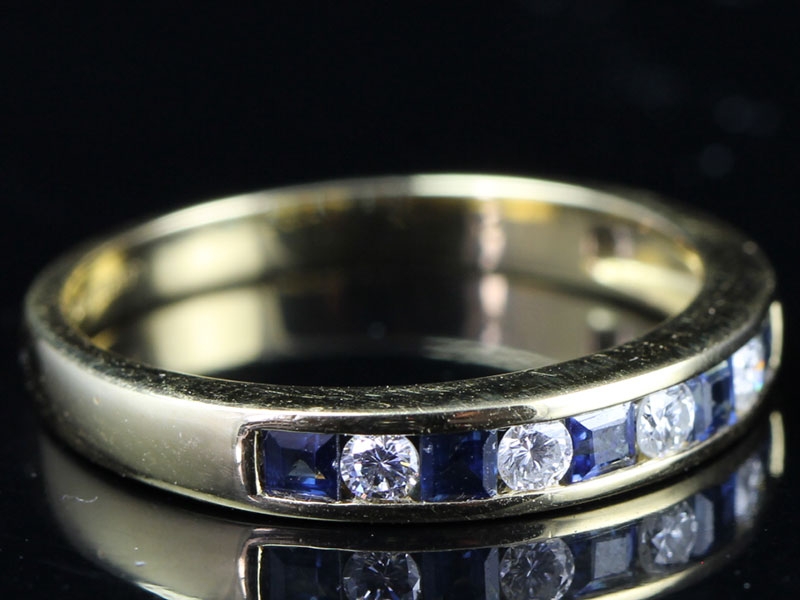 Striking diamond and sapphire 18 carat gold half eternity ring