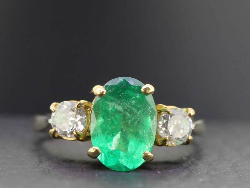 A stylish three stone colombian emerald and diamond 18 carat gold ring