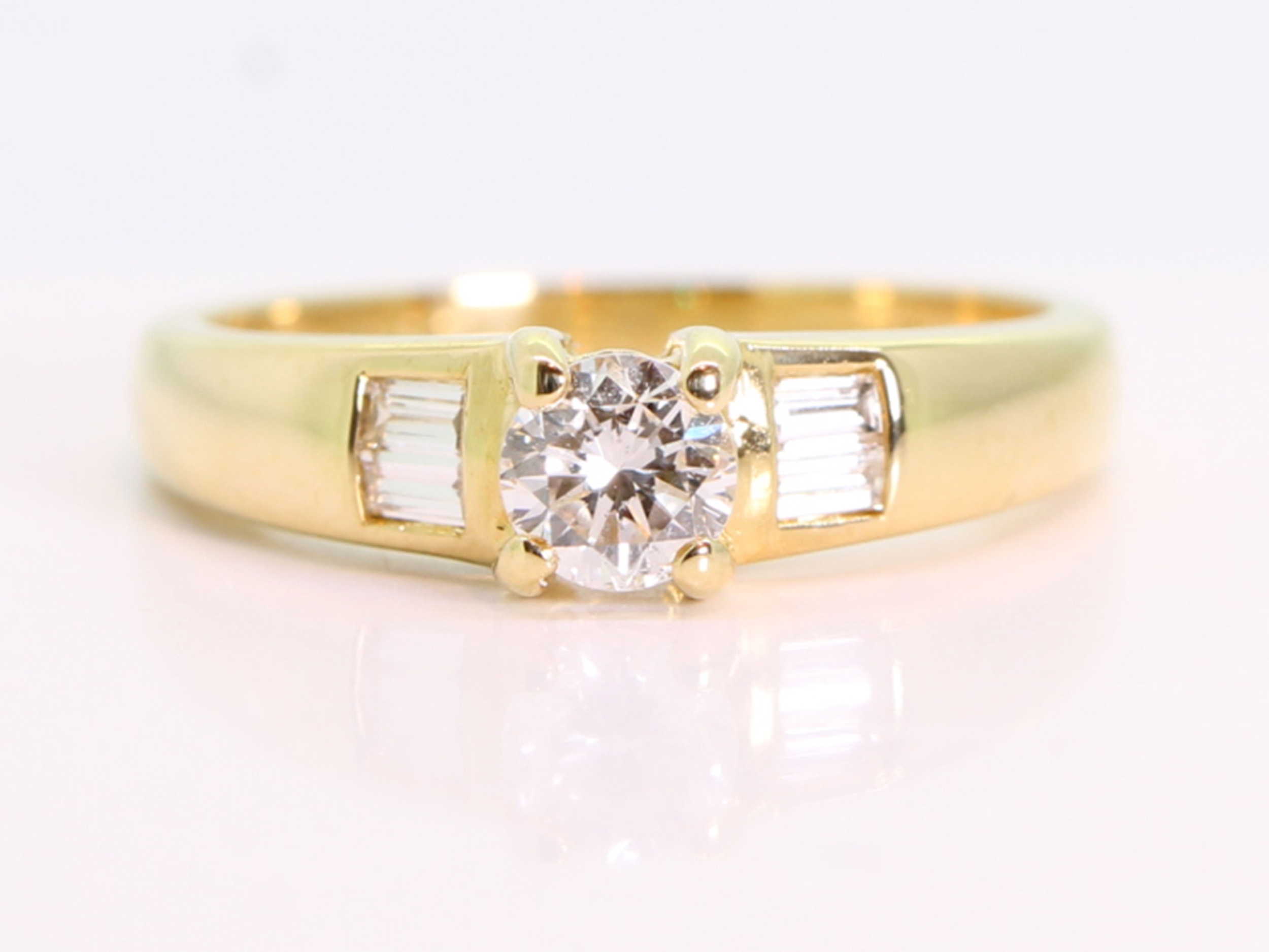 Diamond solitaire with baguette diamond shoulders 18ct gold ring