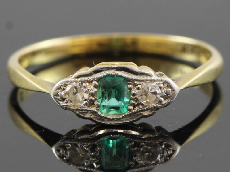 Stylish emerald and diamond platinum and 18 carat gold ring 