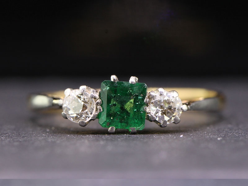 Pretty emerald and diamond 18 carat gold and platinum trilogy ring