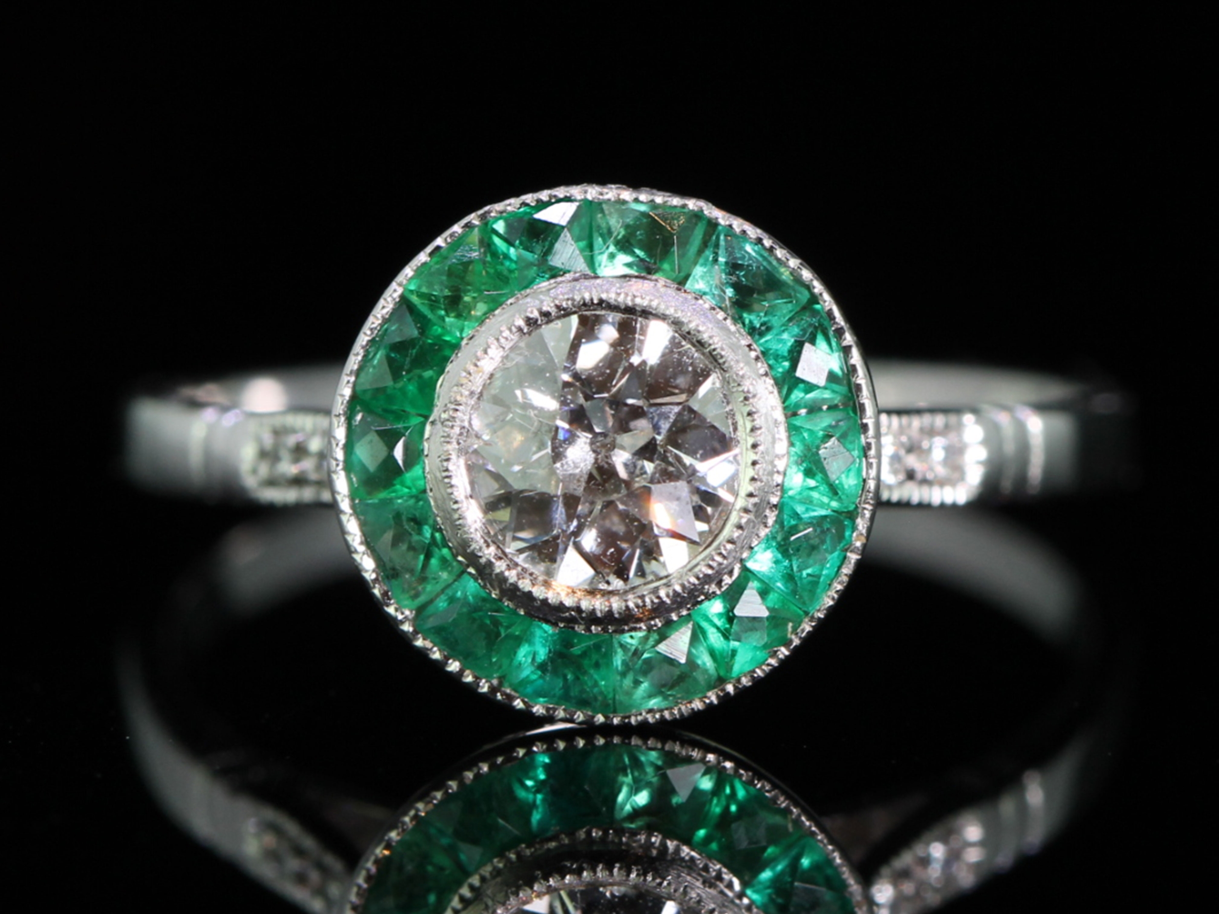 Beautiful diamond and emerald platinum target ring