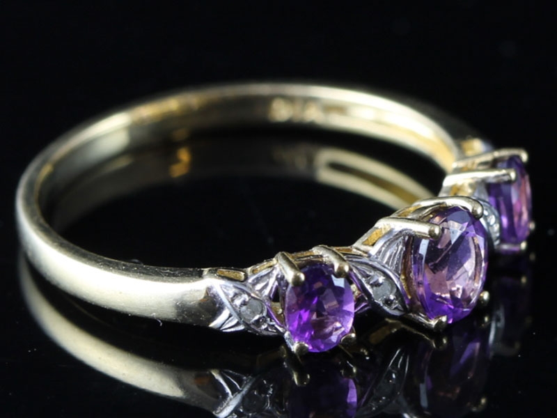  pretty amethyst and diamond three stone 9 carat gold ring