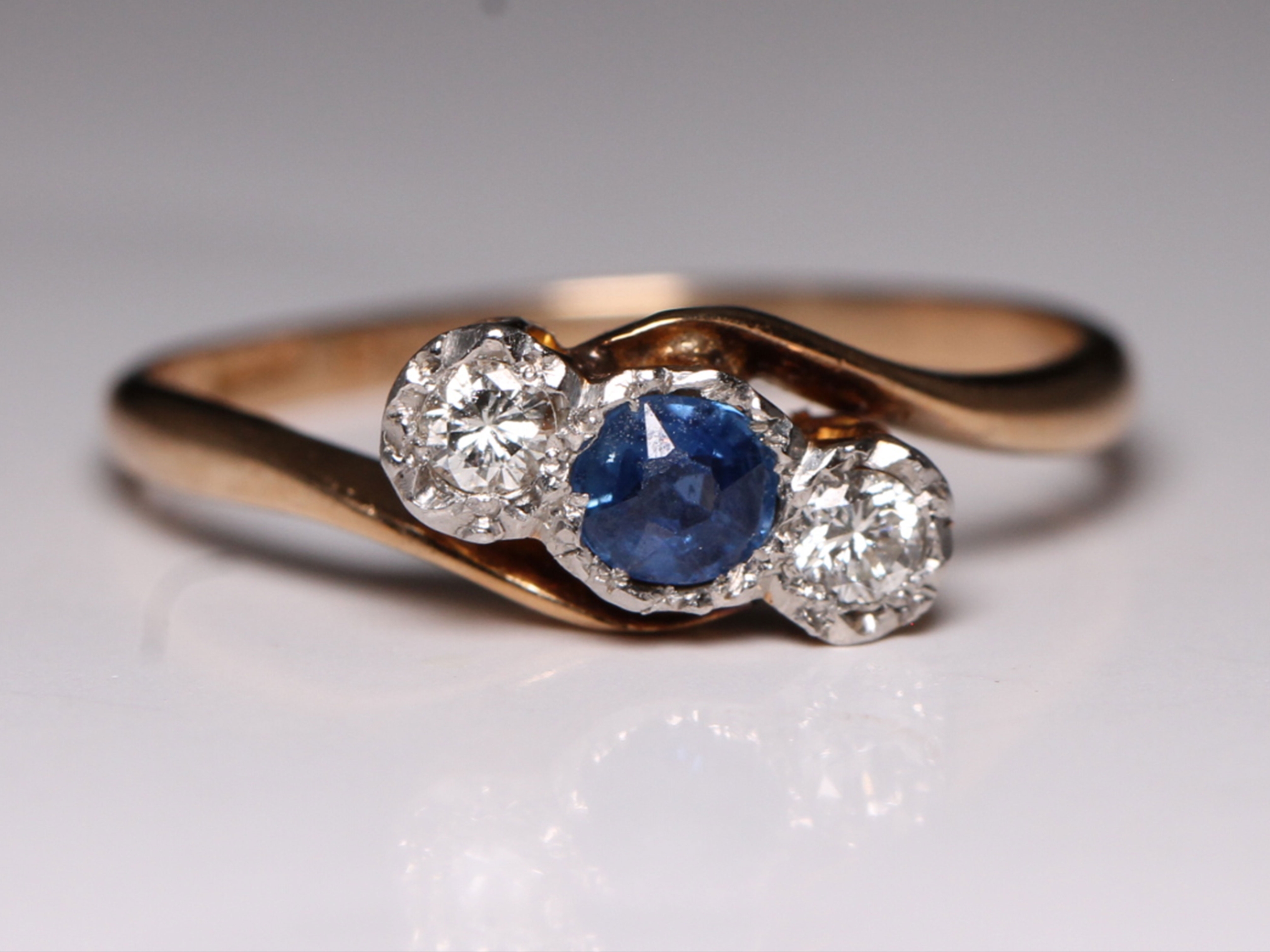 Art deco sapphire and diamond 18ct gold three-stone crossover ring