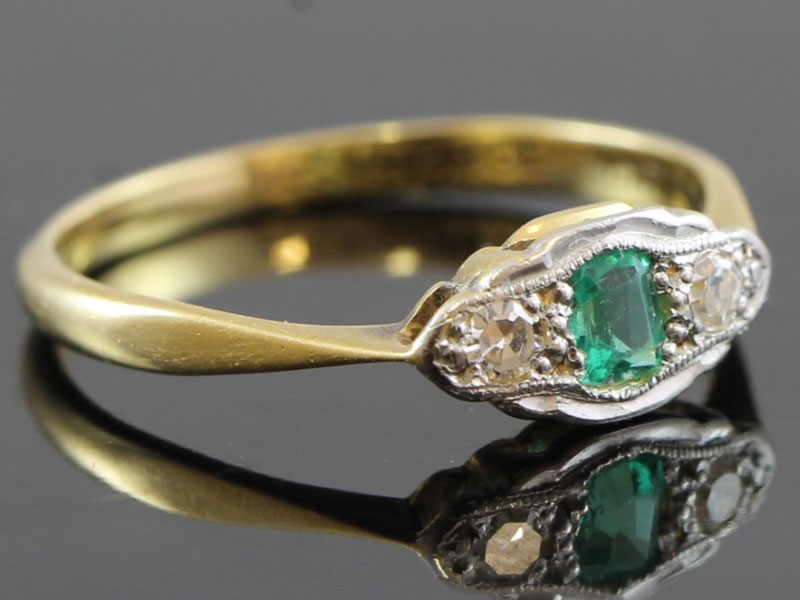 Stylish emerald and diamond platinum and 18 carat gold ring 