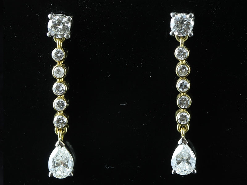 Stunning unique diamond drop earrings with diamond pear shape diamonds in 18 carat gold