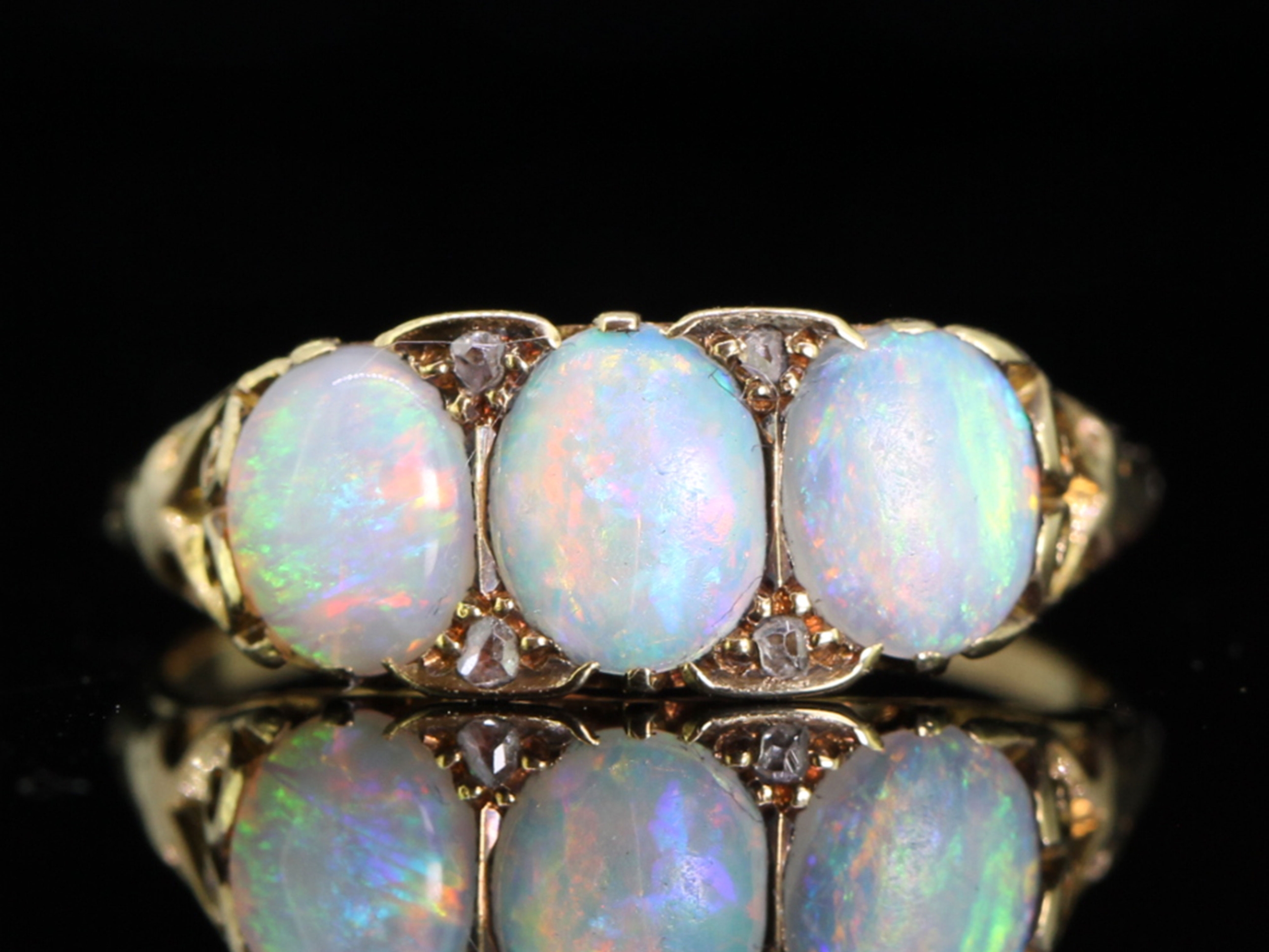 Colourful three stone opal and diamond 18 carat gold ring