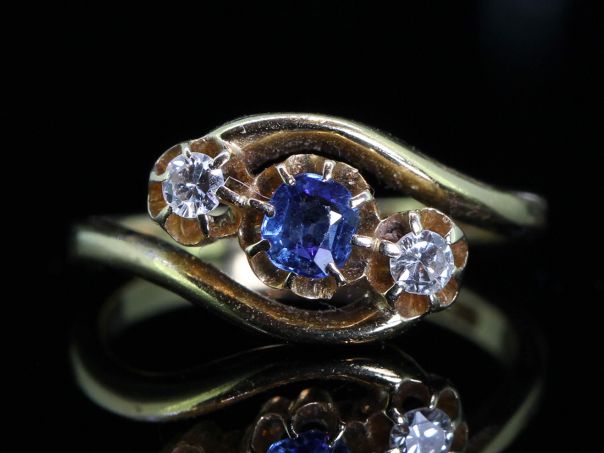 Pretty sapphire and diamond three stone twist ring in 18 carat gold 
