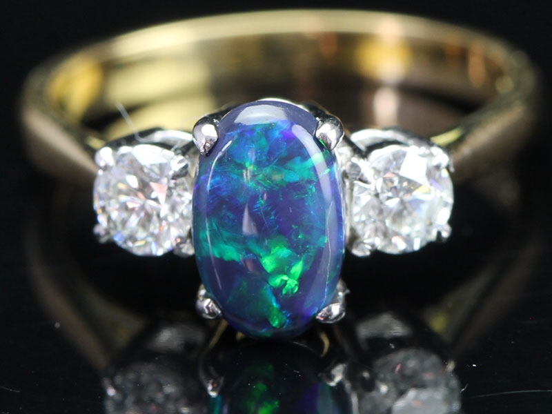 Rare australian black opal and diamond trilogy 18 carat gold ring