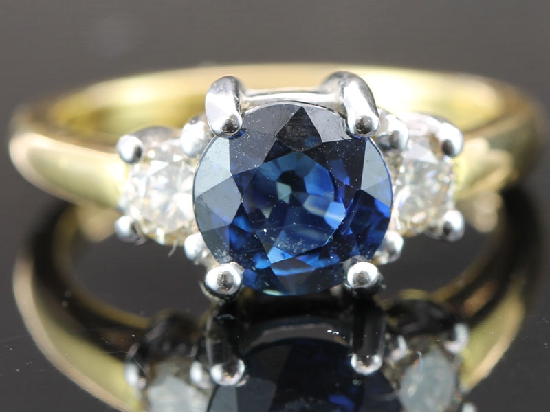 Beautiful deep blue sapphire and diamond trilogy 18 carat gold ring