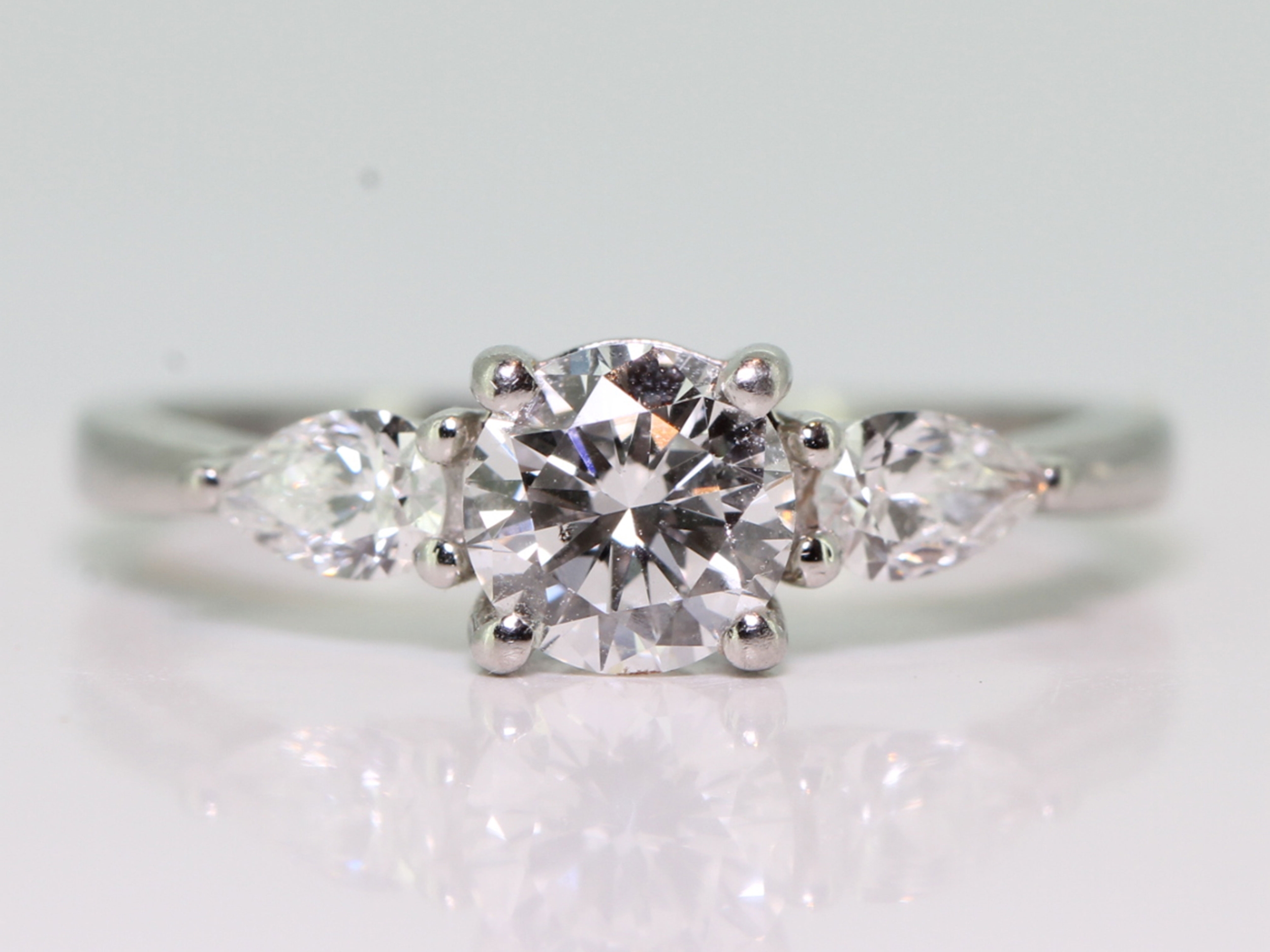 Stunning platinum brilliant and pear cut diamond trilogy ring