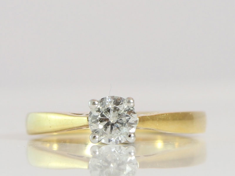 A classic round brilliant cut solitaire diamond ring in 18 carat gold