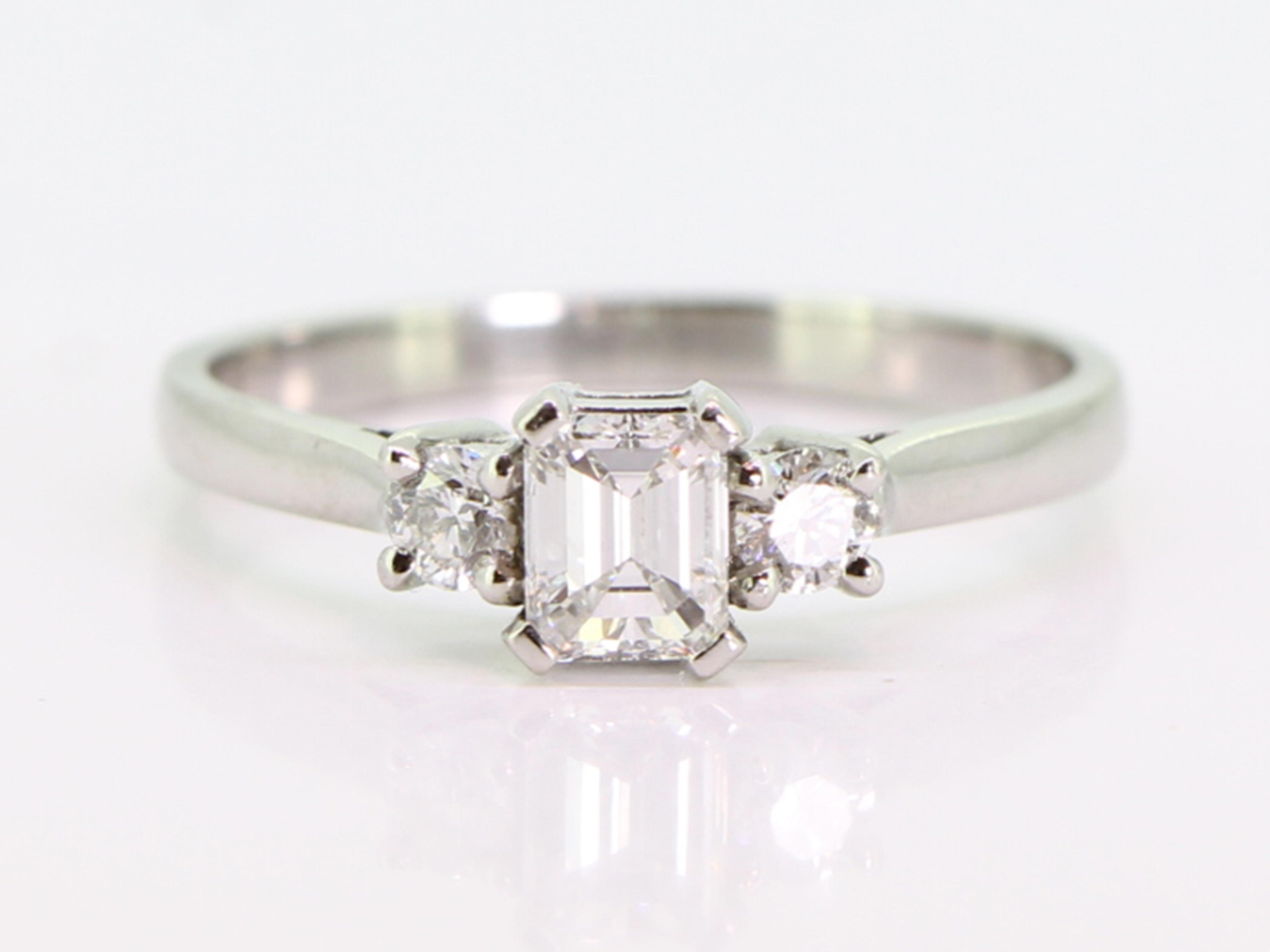 Beautiful emerald cut diamond platinum trilogy ring