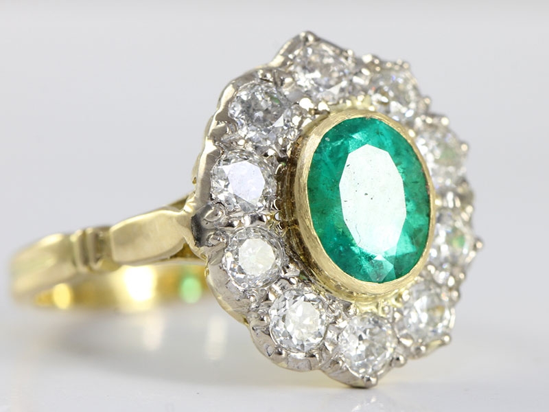  a mesmerising emerald and diamond cluster 18 carat gold ring
