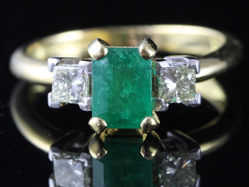 Classic emerald cut columbian emerald and diamond trilogy 18 carat gold ring