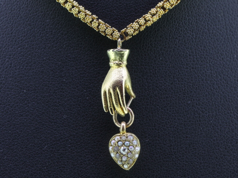 Unique 15 carat gold hand and chain with a pearl and diamond heart pendant