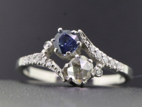 ELEGANT TWO STONE DIAMOND AND SAPPHIRE PLATINUM RING ON A TWIST